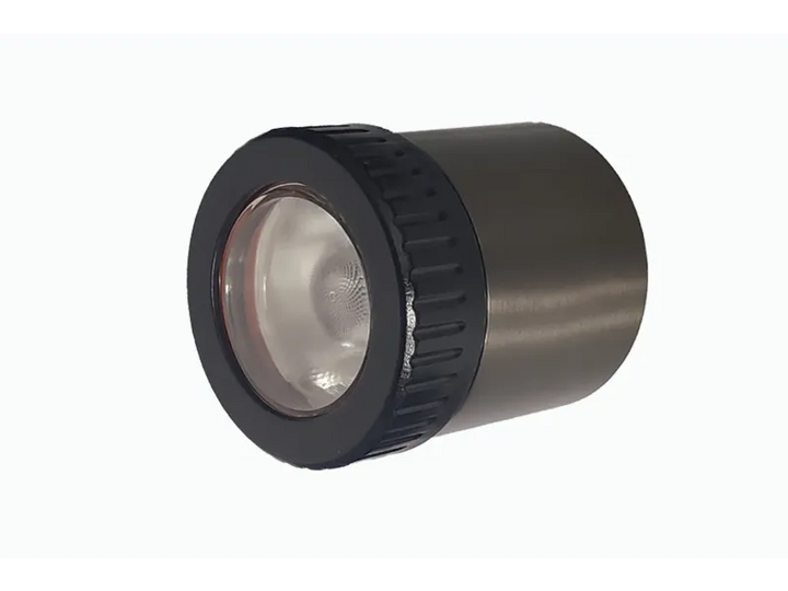 Close-up of the Lumien Lighting LumienPRO fixture, featuring a sleek cylindrical design with a black rim and durable brass finish.