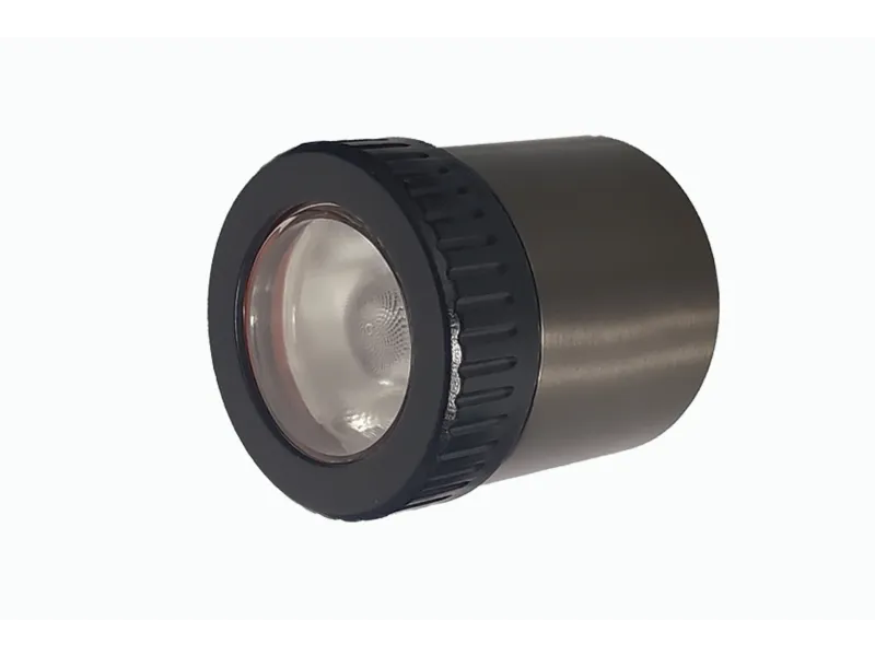 Close-up of the Lumien Lighting LumienPRO fixture, featuring a sleek cylindrical design with a black rim and durable brass finish.