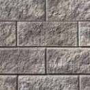 Grey split faced retaining wall block.